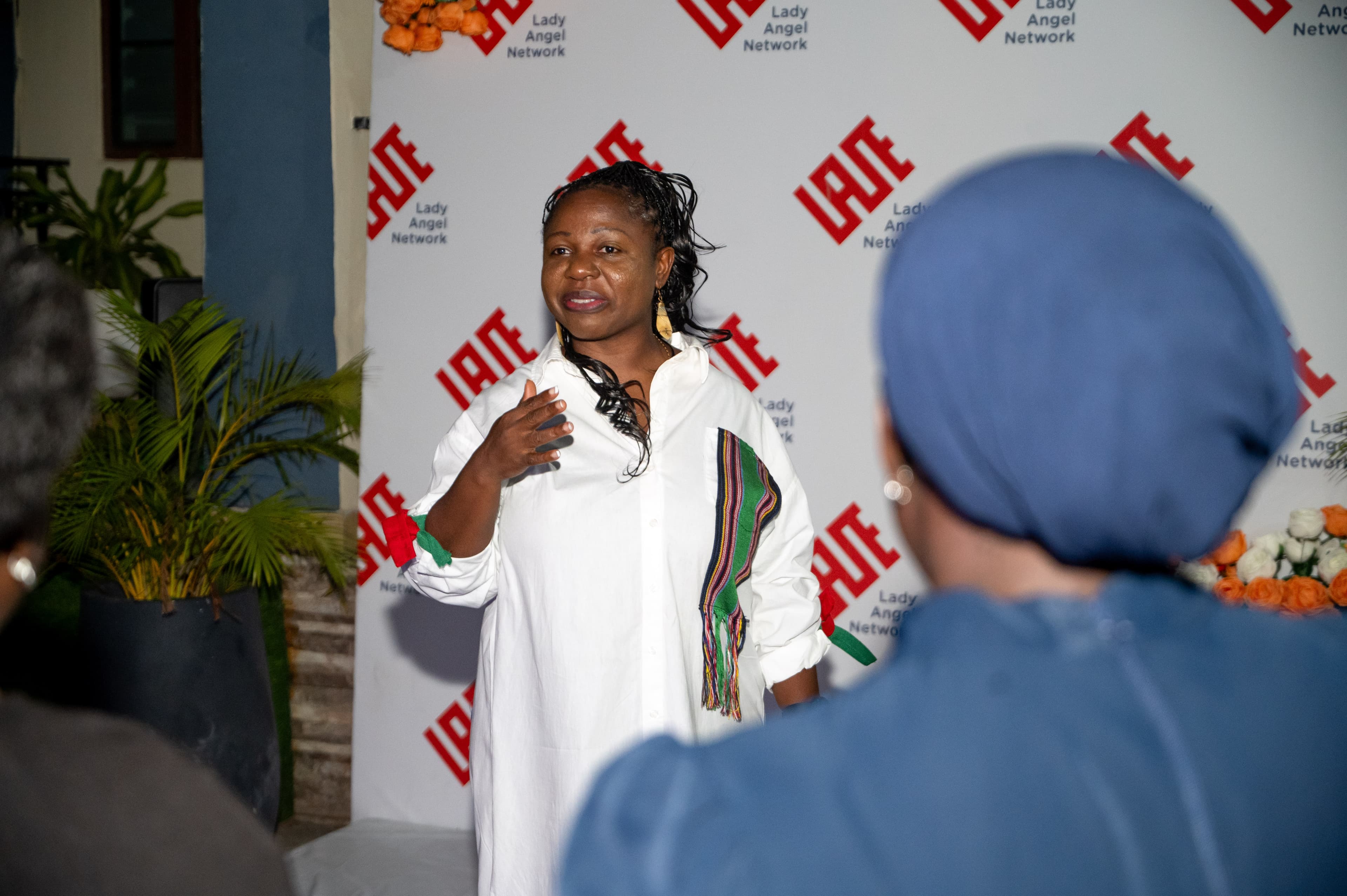A speaker addressing attendees at a Lady Angel Network event.